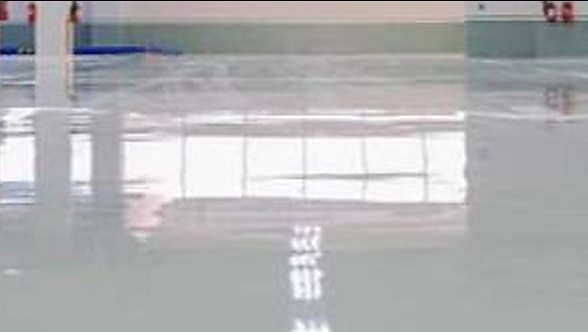 Industrial epoxy floor recoat by DTI Freshly recoated industrial epoxy floor by DTI