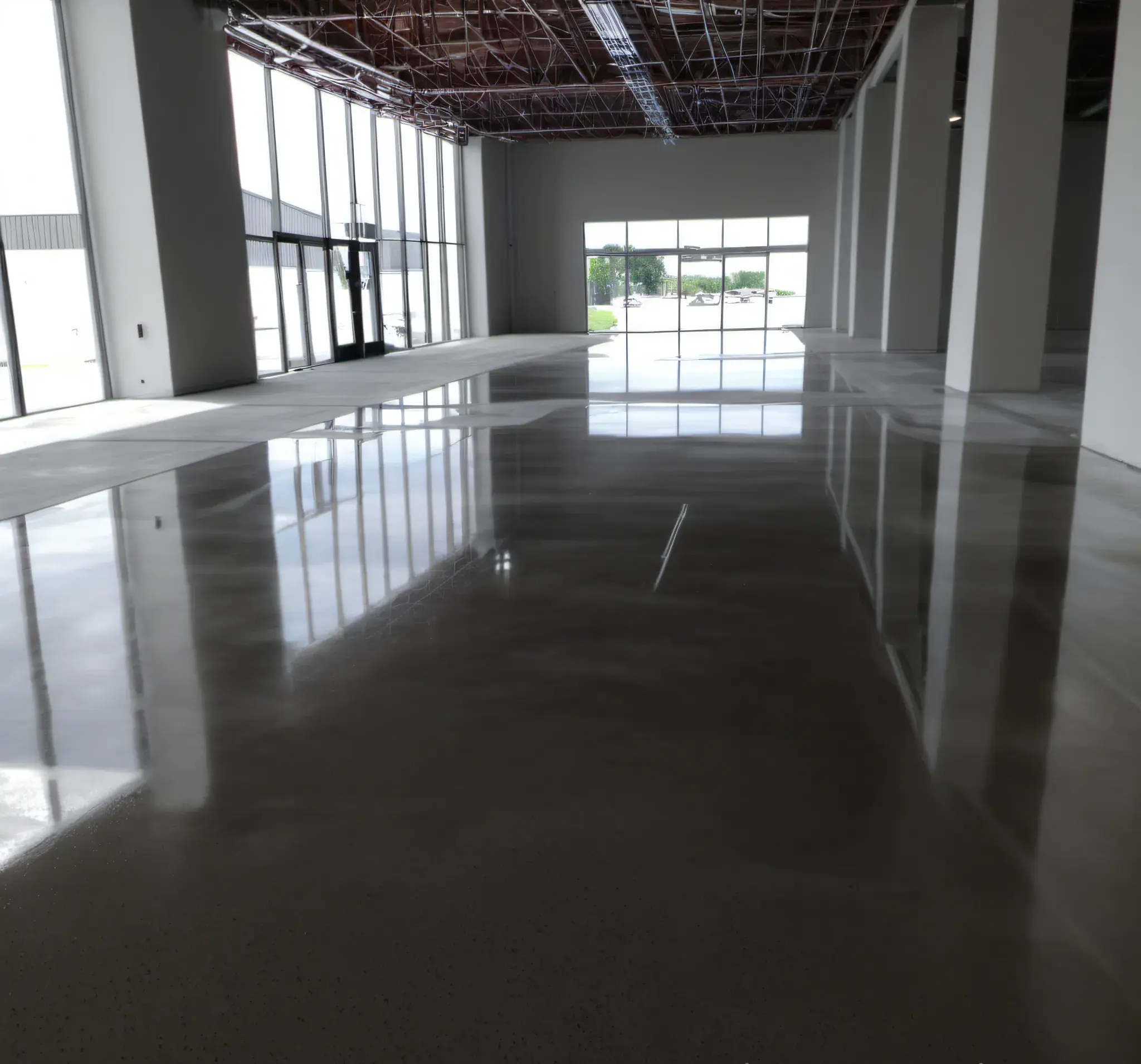 An industrial building interior work in progress, with finished, concrete, polished floors.