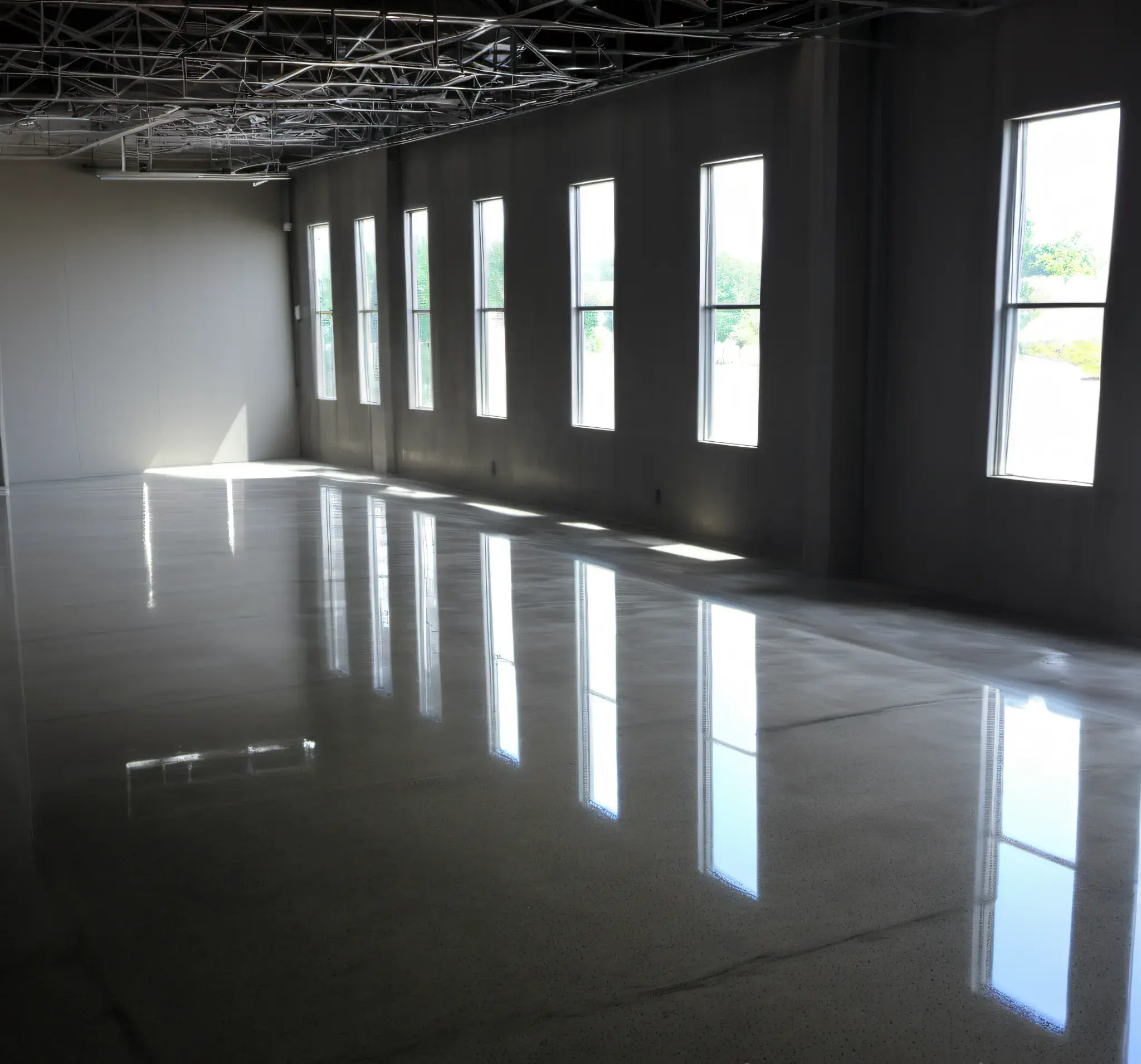 Sealed concrete flooring, set in a commercial, small building, with light shafts and reflections running along the sidewalk, taken at an angle